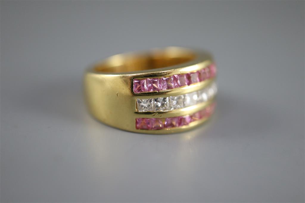 A modern 18ct gold, diamond and pink sapphire set three row dress ring,